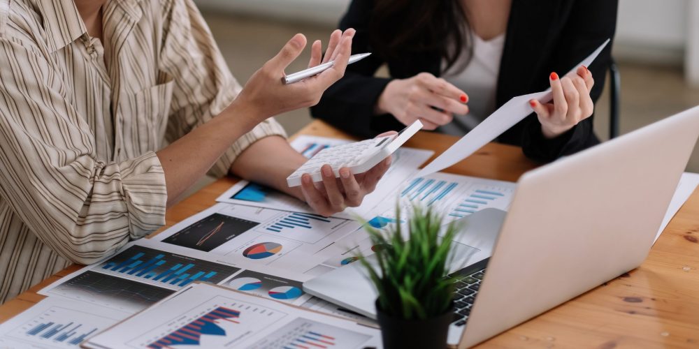 Business adviser meeting to analyze and discuss the situation on the financial report in the meeting room.Investment Consultant,Financial Consultant,Financial advisor and accounting concept